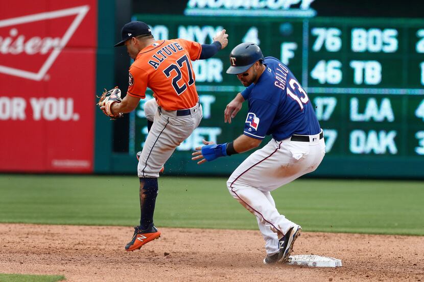 Houston Astros second baseman Jose Altuve (27) beats Texas Rangers' Joey Gallo (13) to...