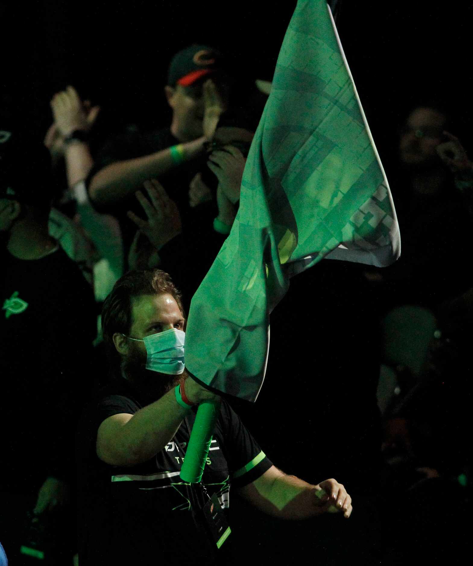 A fan waves a flag as fans cheer during OpTic Texas' first match of the day against London...