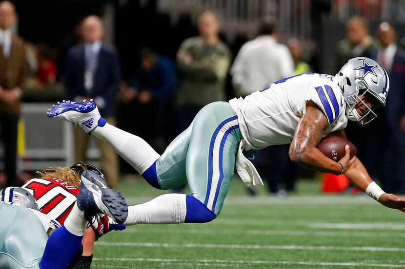 Dallas Cowboys quarterback Dak Prescott (4) is sacked by Atlanta Falcons defensive end...