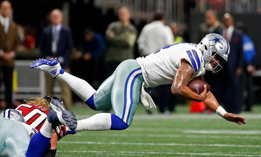 Dallas Cowboys quarterback Dak Prescott (4) is sacked by Atlanta Falcons defensive end...