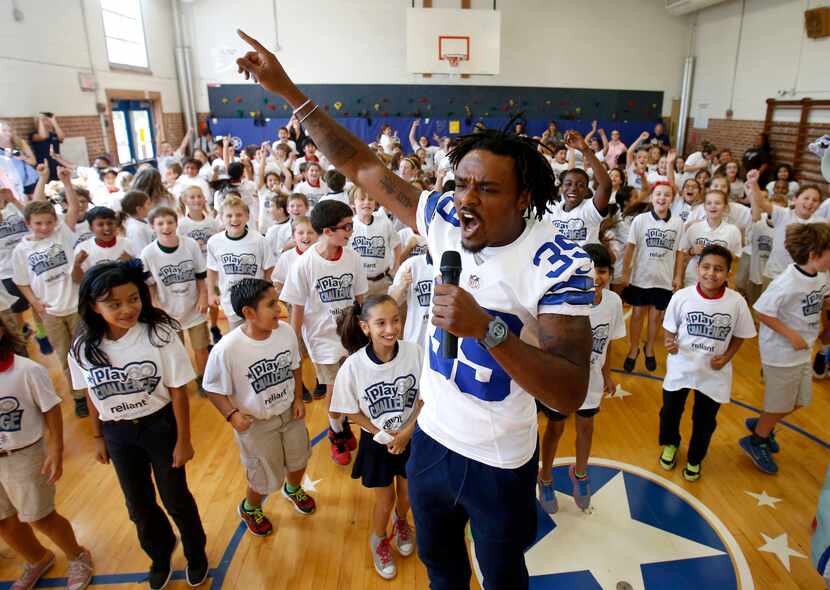 Dallas Cowboys cornerback Brandon Carr (39) gets the students warmed up during a pep rally...