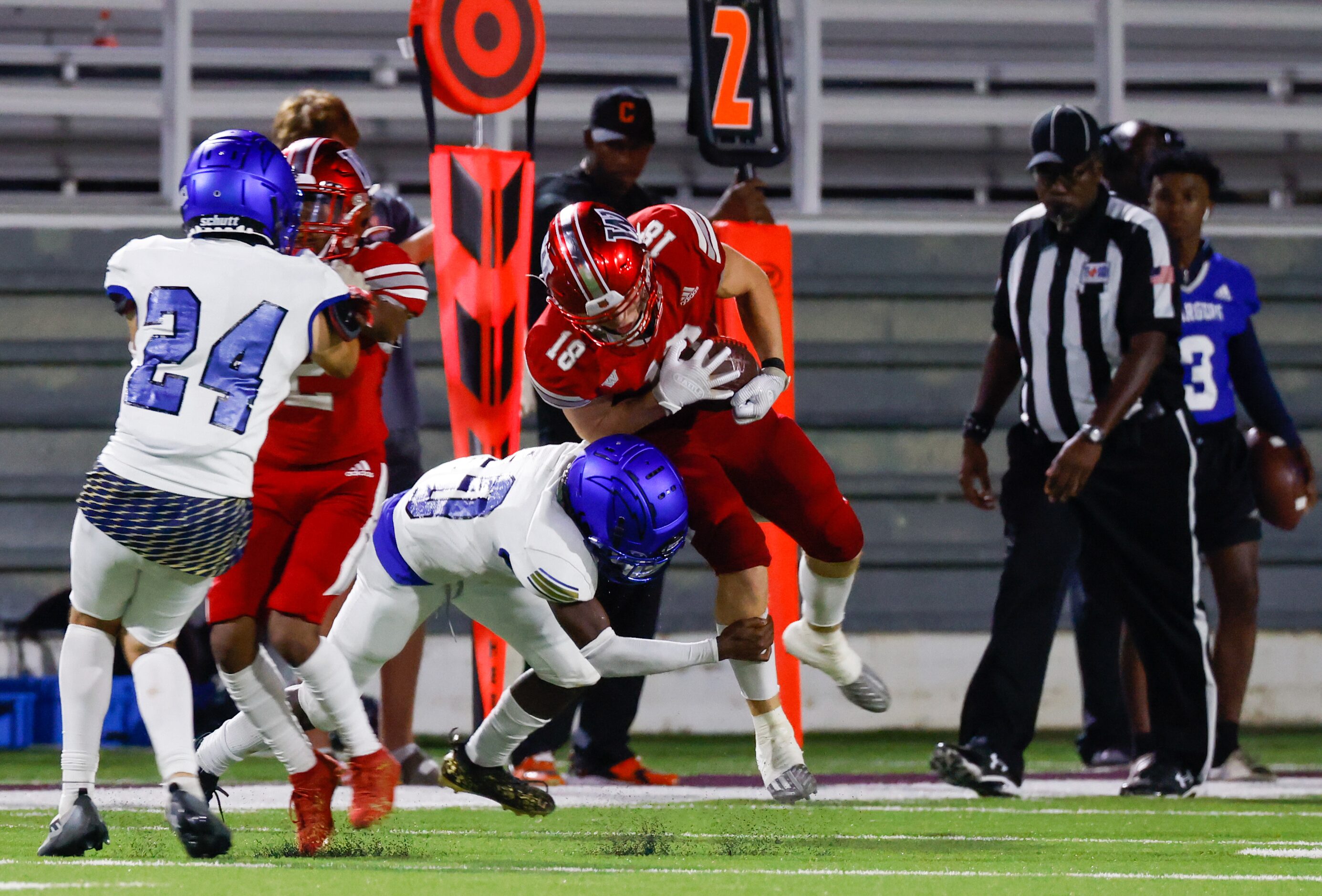 Woodrow Wilson wide receiver Graydon Thompson (18) takes a hit from Conrad defensive back...