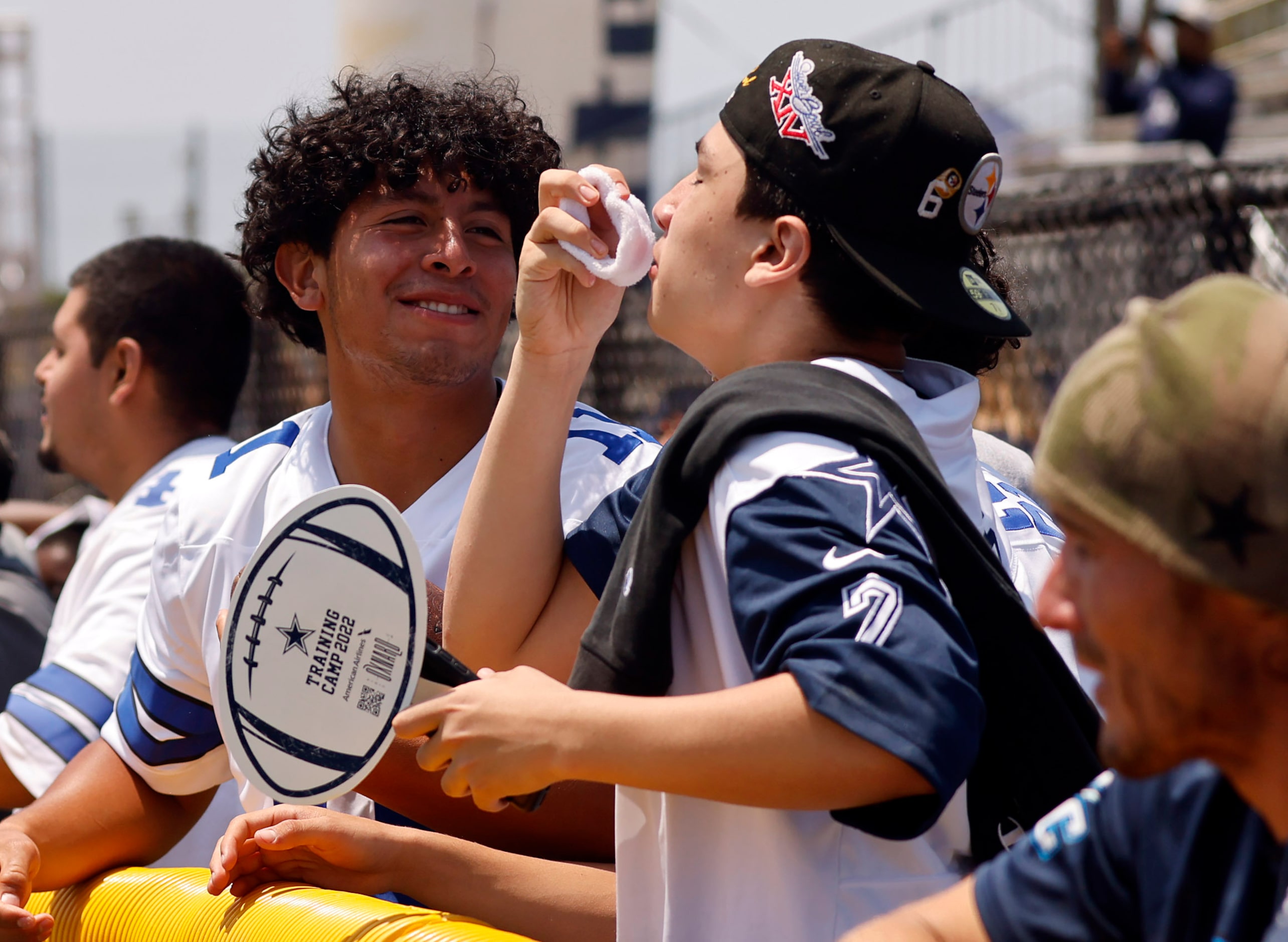 Bennie Murillo of Santa Barbara, California kisses a wrist band thrown to him by Dallas...