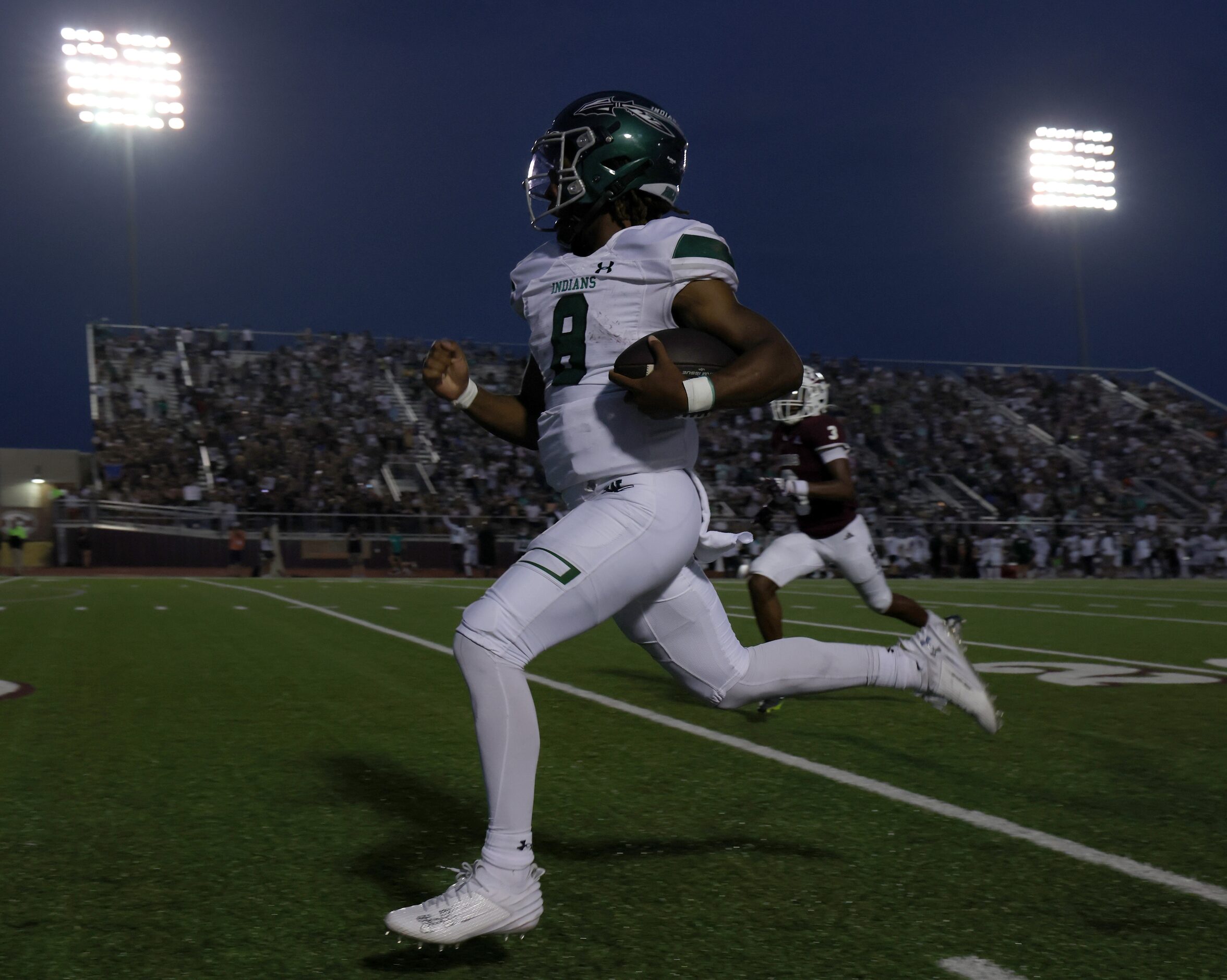 Waxahachie quarterback Ramon McKinney Jr. (8) rushes into the Ennis secondary during first...