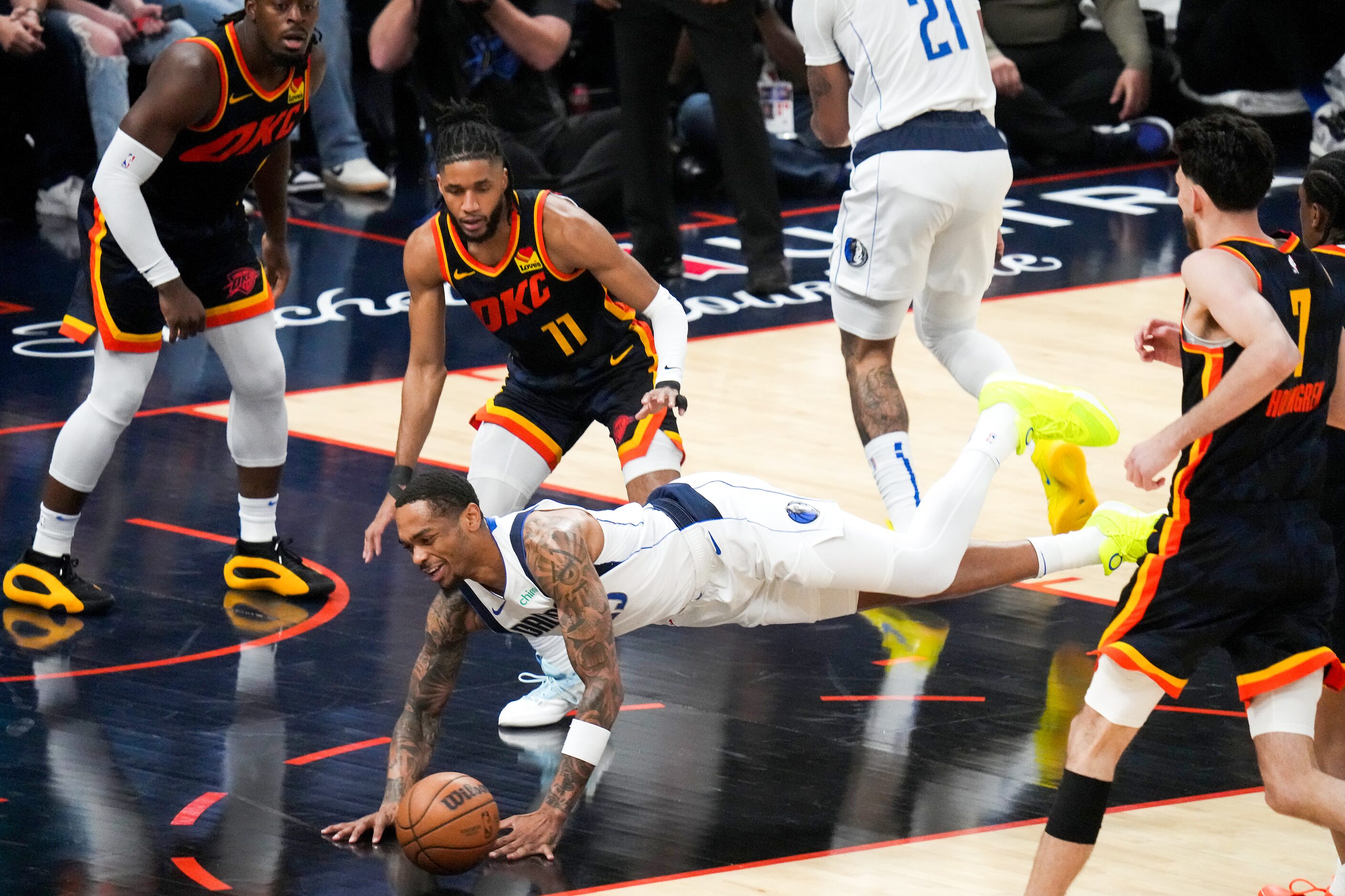 Dallas Mavericks forward P.J. Washington (25) falls to the floor as Oklahoma City Thunder...