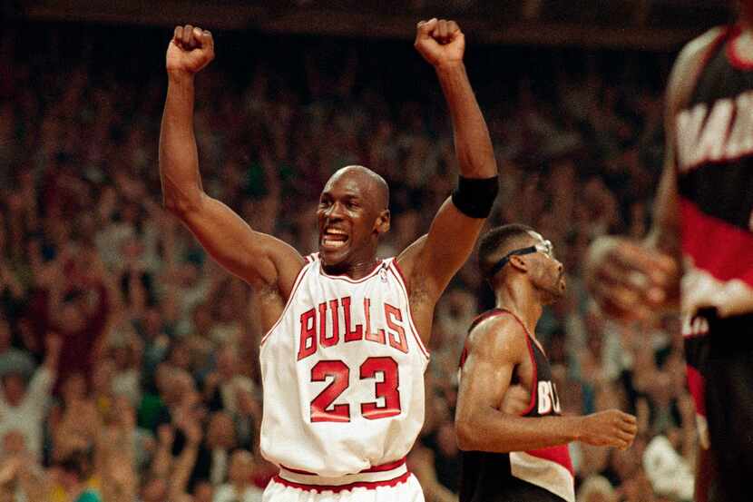 In this June 14, 1992, file photo, Michael Jordan celebrates the Bulls win over the Portland...