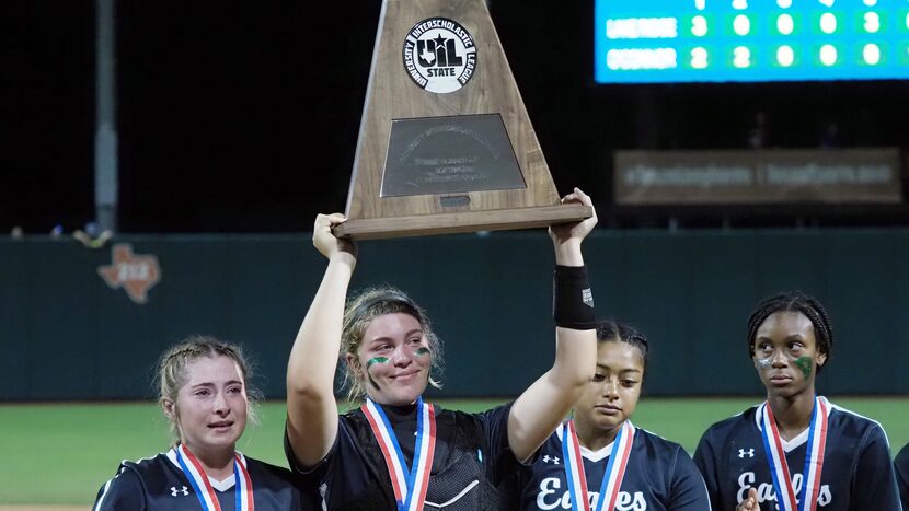 Mansfield Lake Ridge catcher Reign Brannon hoists the second place trophy after a defeat...