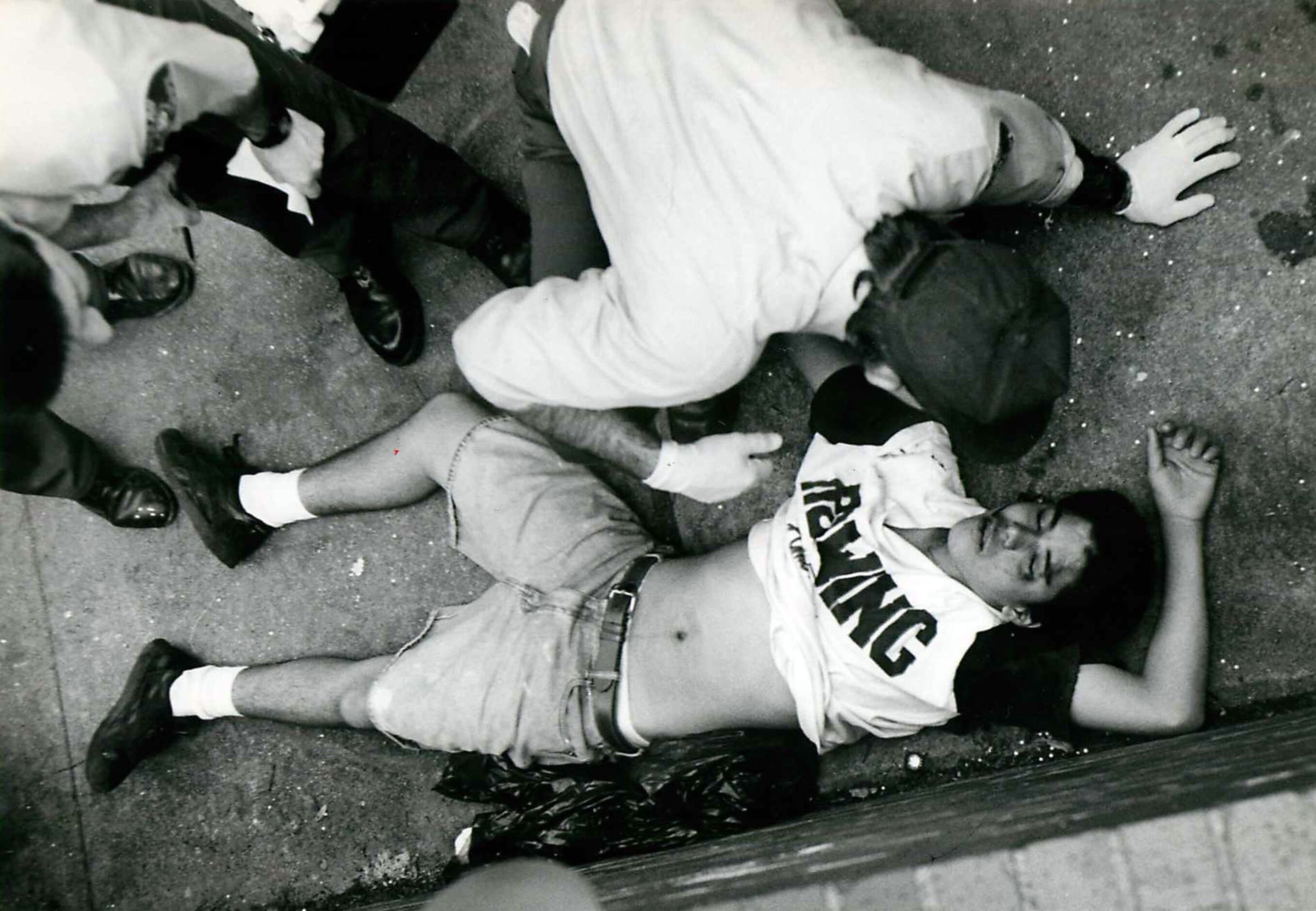 A Dallas fireman helps Mario Rodriguez, 16, of Dallas after he was involved in a fight at...