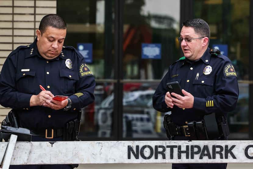 Dallas police officers stand outside the NorthPark Center on Monday.