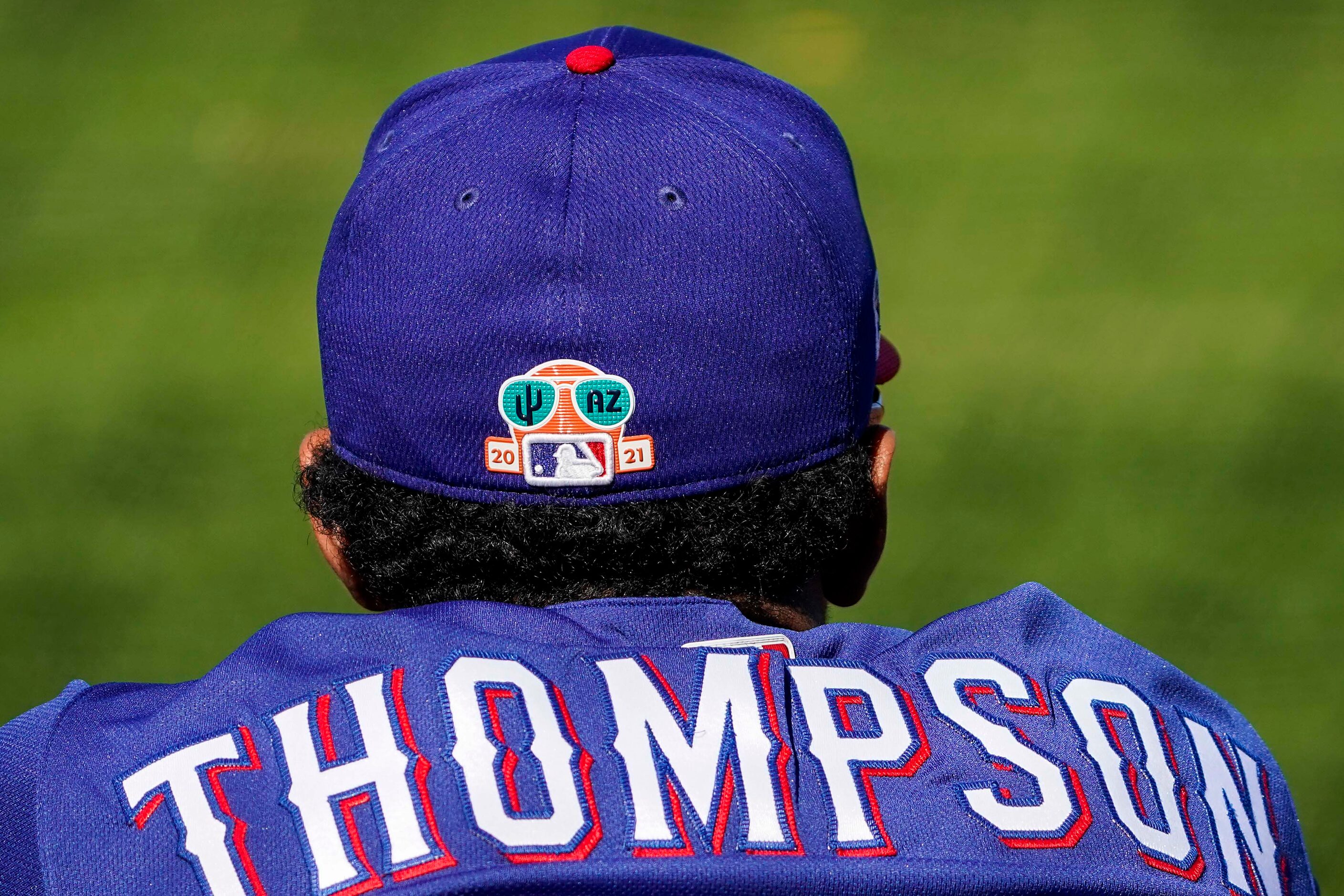 Texas Rangers catcher Sam Huff watches from the dugout during the fifth inning of a spring...