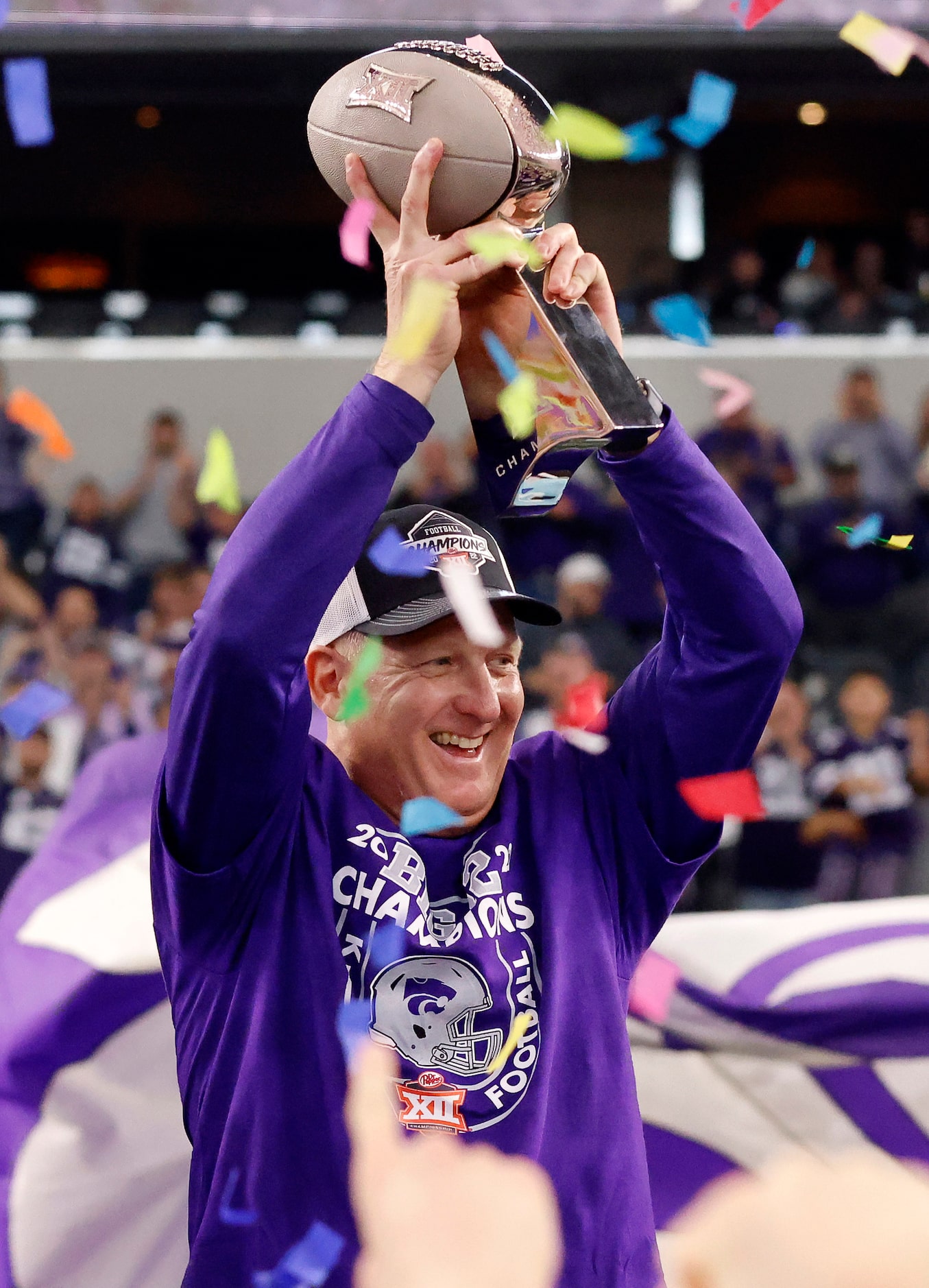 Kansas State Wildcats head coach Chris Klieman raises the Big XII Championship trophy after...