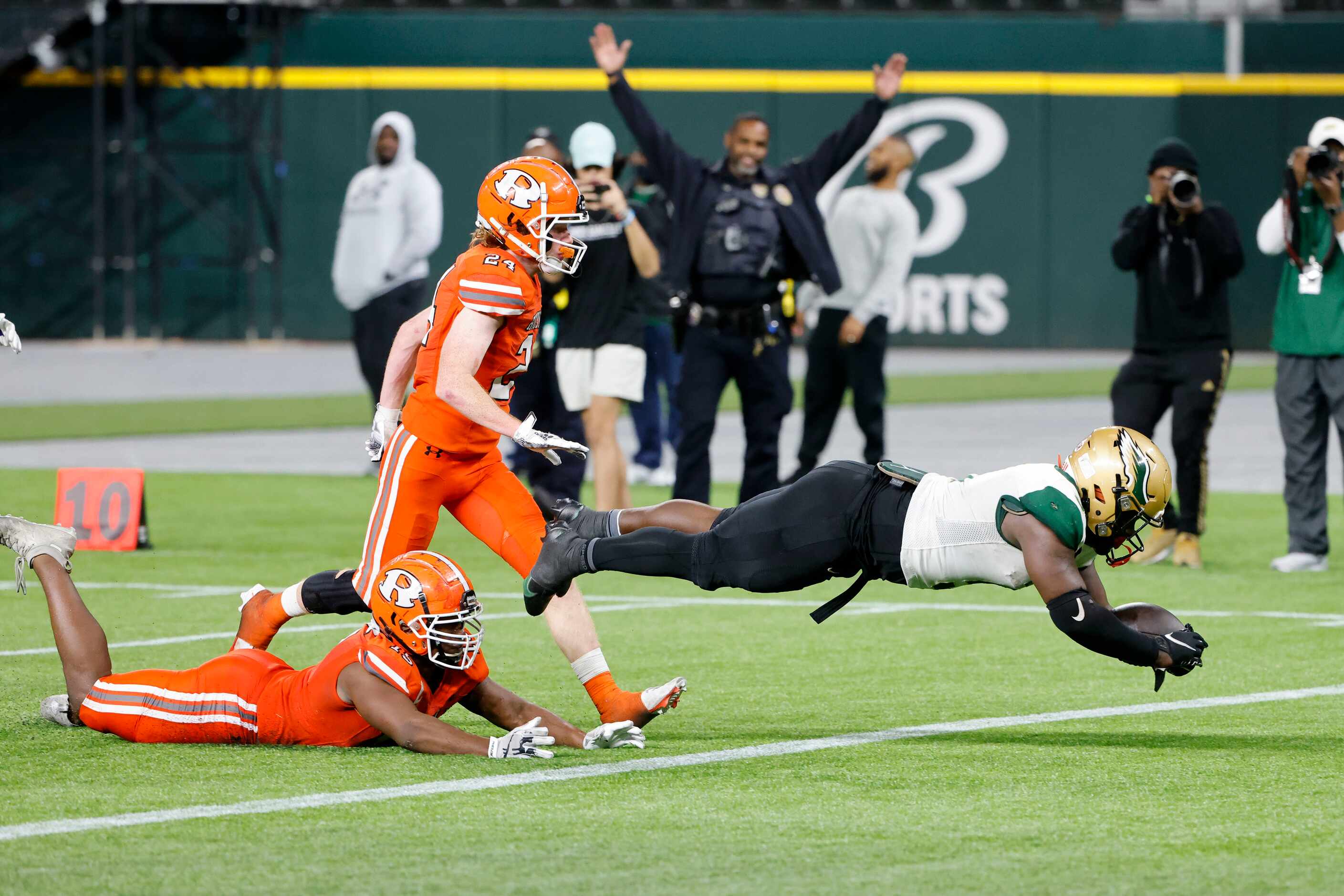 Desoto running back Christopher Henley Jr. scores a touchdown in front of Rockwall defenders...