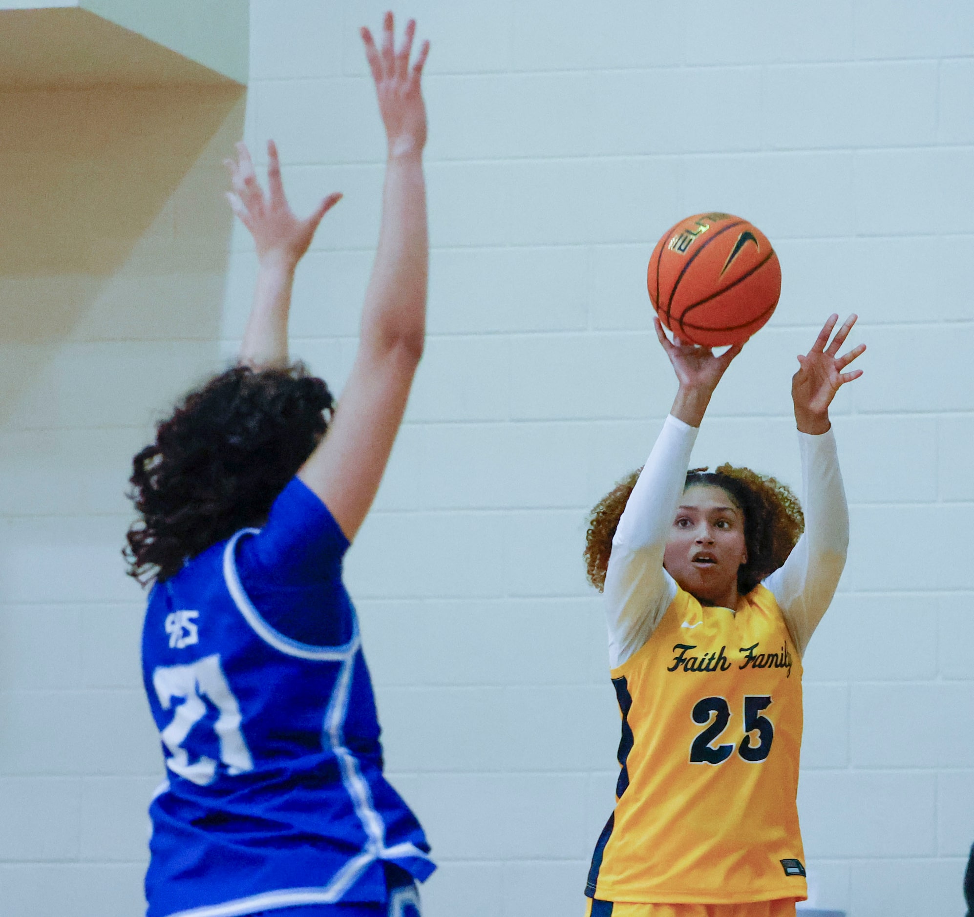 Oak Cliff Faith Family Academy’s Amayah Garcia (right) shoots a three pointer past IMG...