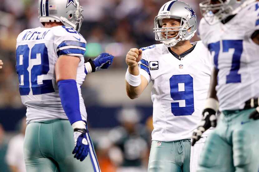 Dallas Cowboys quarterback Tony Romo (9) is all smiles with Dallas Cowboys tight end Jason...