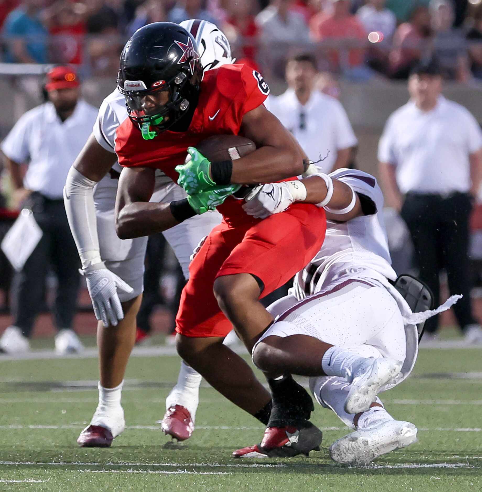 Coppell running back O'Marion Mbakwe (6) tries to break a tackle against Lewisville...
