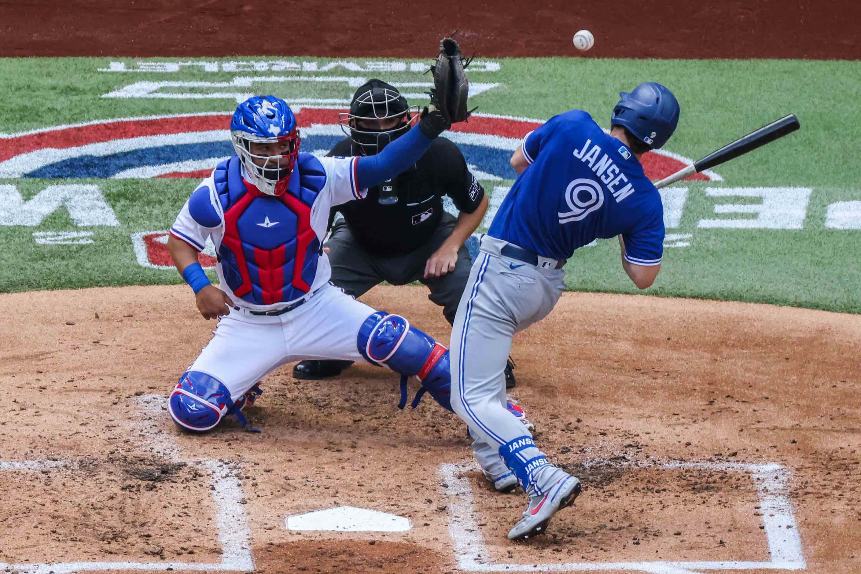 Toronto Blue Jays' Danny Jansen No. 9 dodges a ball in home plate at the Globe Life Field...
