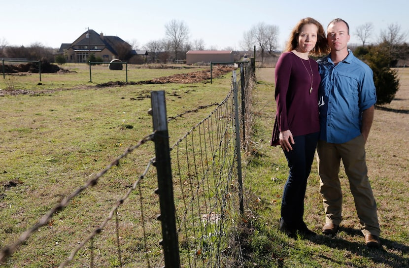 Stephanie and Matt Weyenberg pose for a portrait in the backyard of their five acre property...