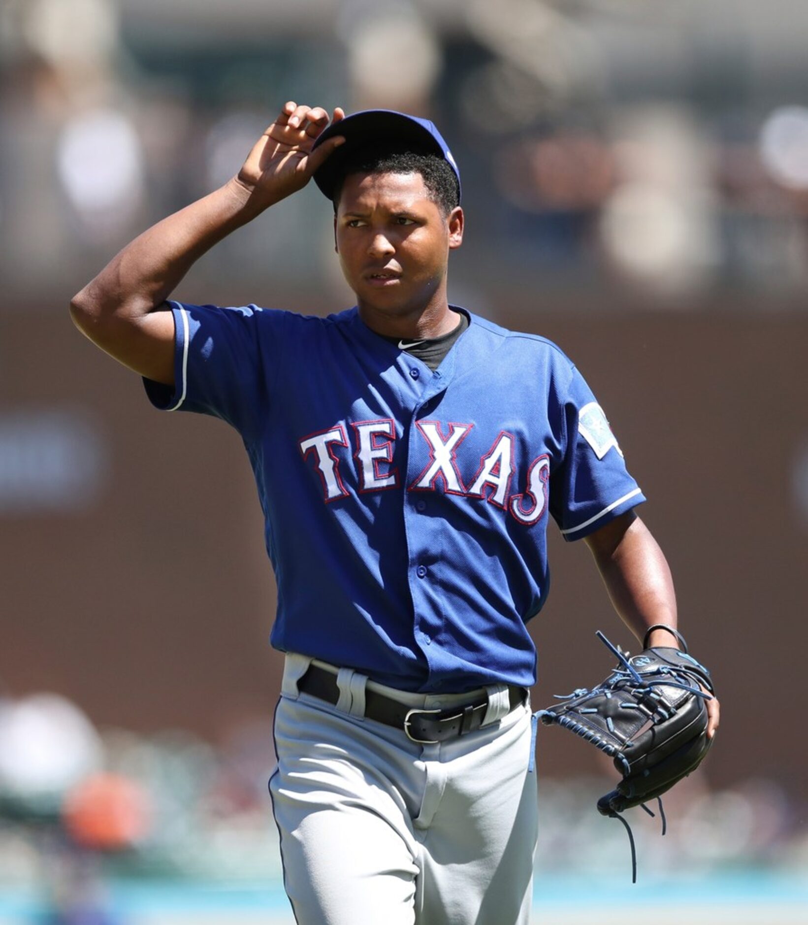 Texas Rangers relief pitcher Jose Leclerc walks to the dugout after the seventh inning of a...