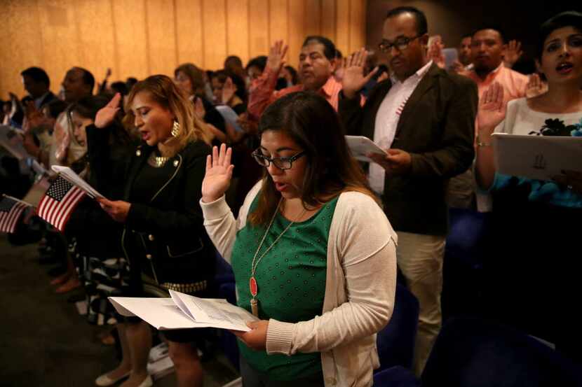 Adriana Sellers from Argentina takes the Oath of Allegiance to become a U.S. citizen during...