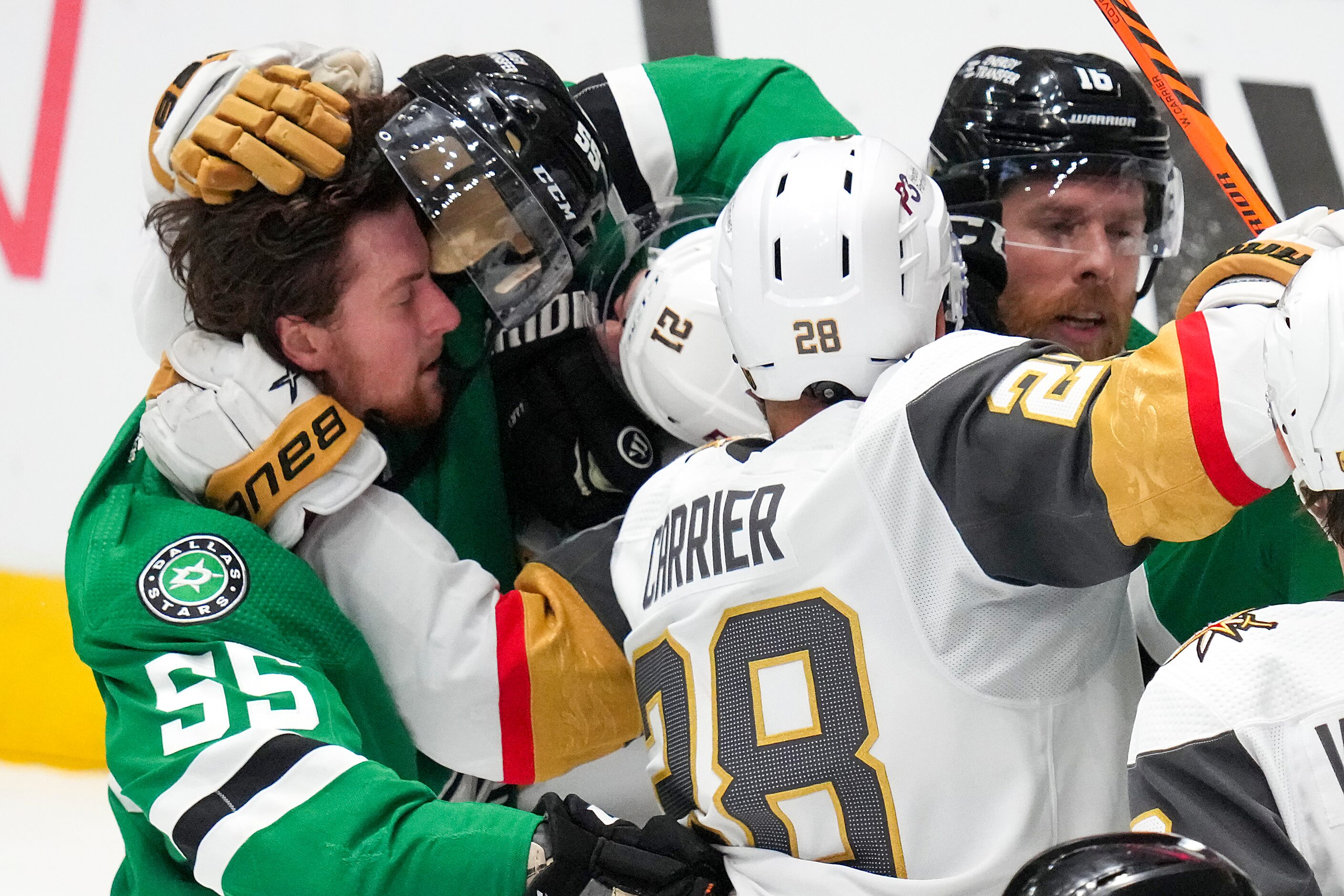 Dallas Stars defenseman Thomas Harley (55) has his helmet knocked off in a tussle with Vegas...