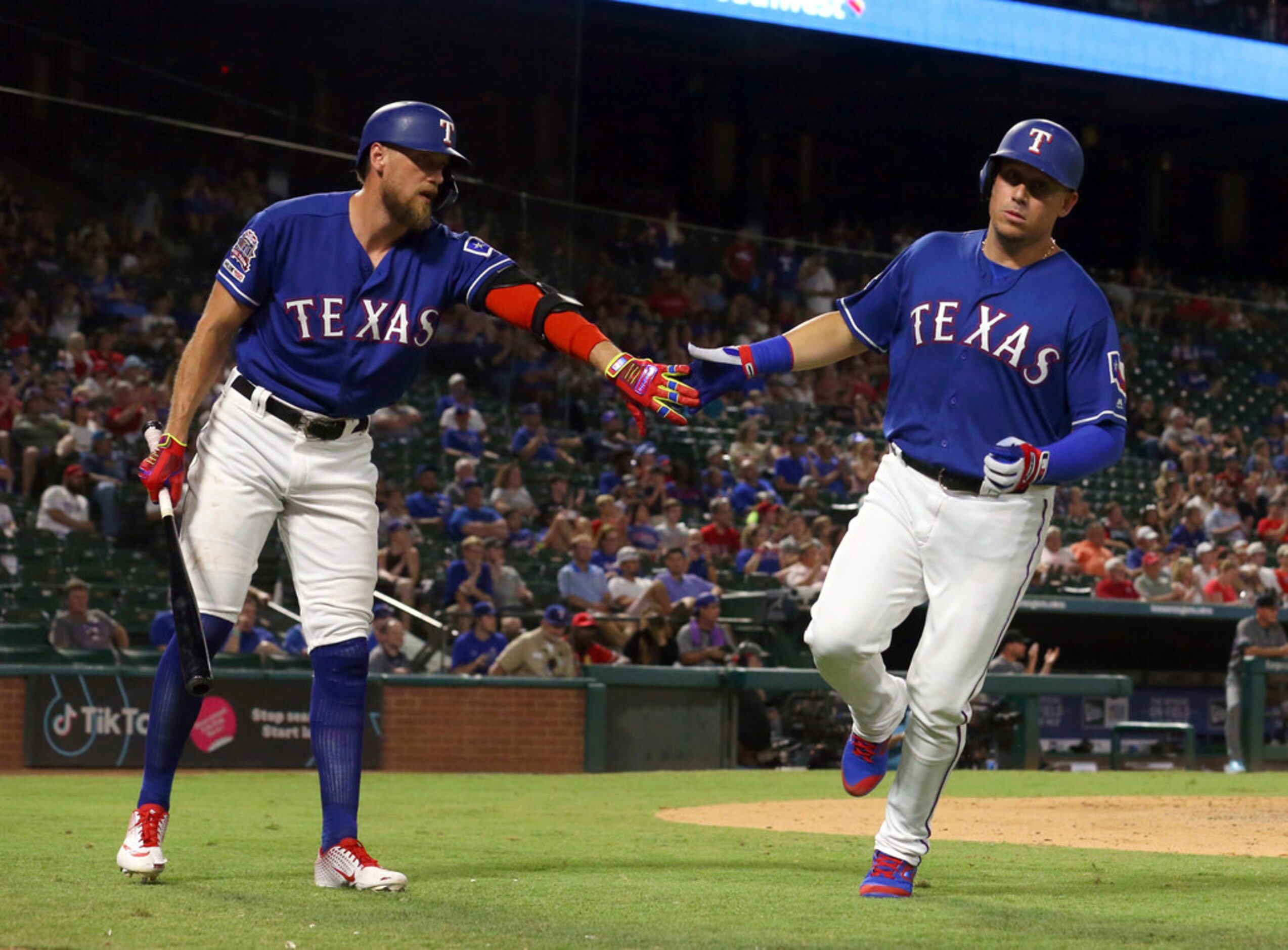 Texas Rangers Hunter Pence, left, greets Asdrubal Cabrera, who scored on a sacrifice fly by...