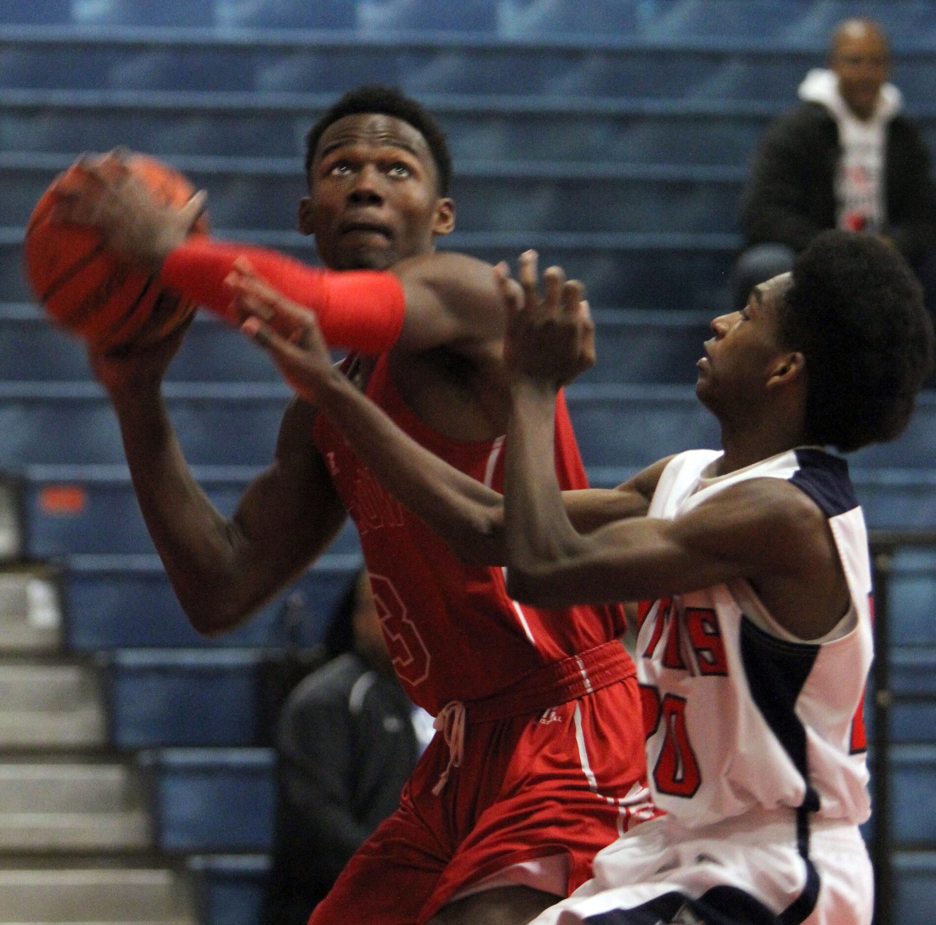 Woodrow Wilson's Hassan Thomas (3) eyes the basket as he is defended by Frisco Centennial...