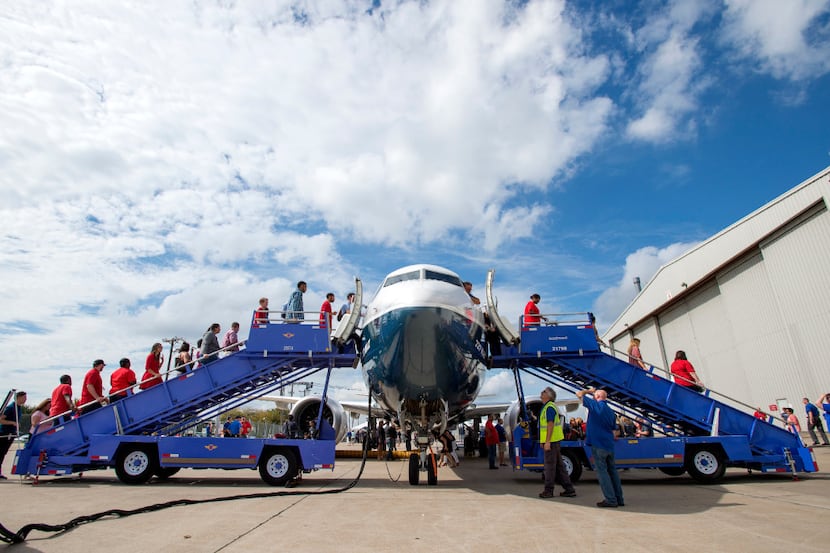 Southwest Airlines employees line up to have a first look at the new Boeing 737 MAX jetliner...