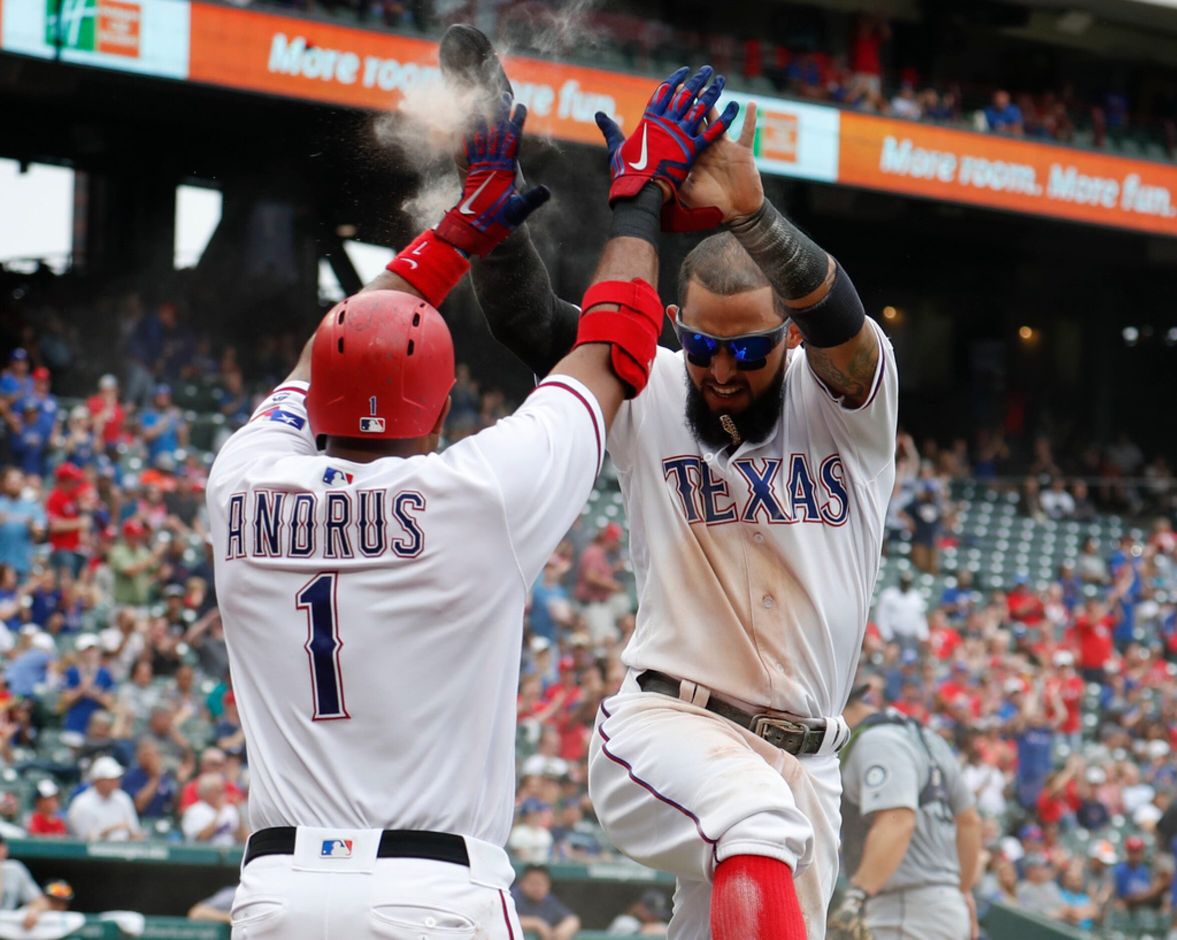 Texas Rangers' Elvis Andrus (1) and Rougned Odor, right, celebrate their runs scored on a...