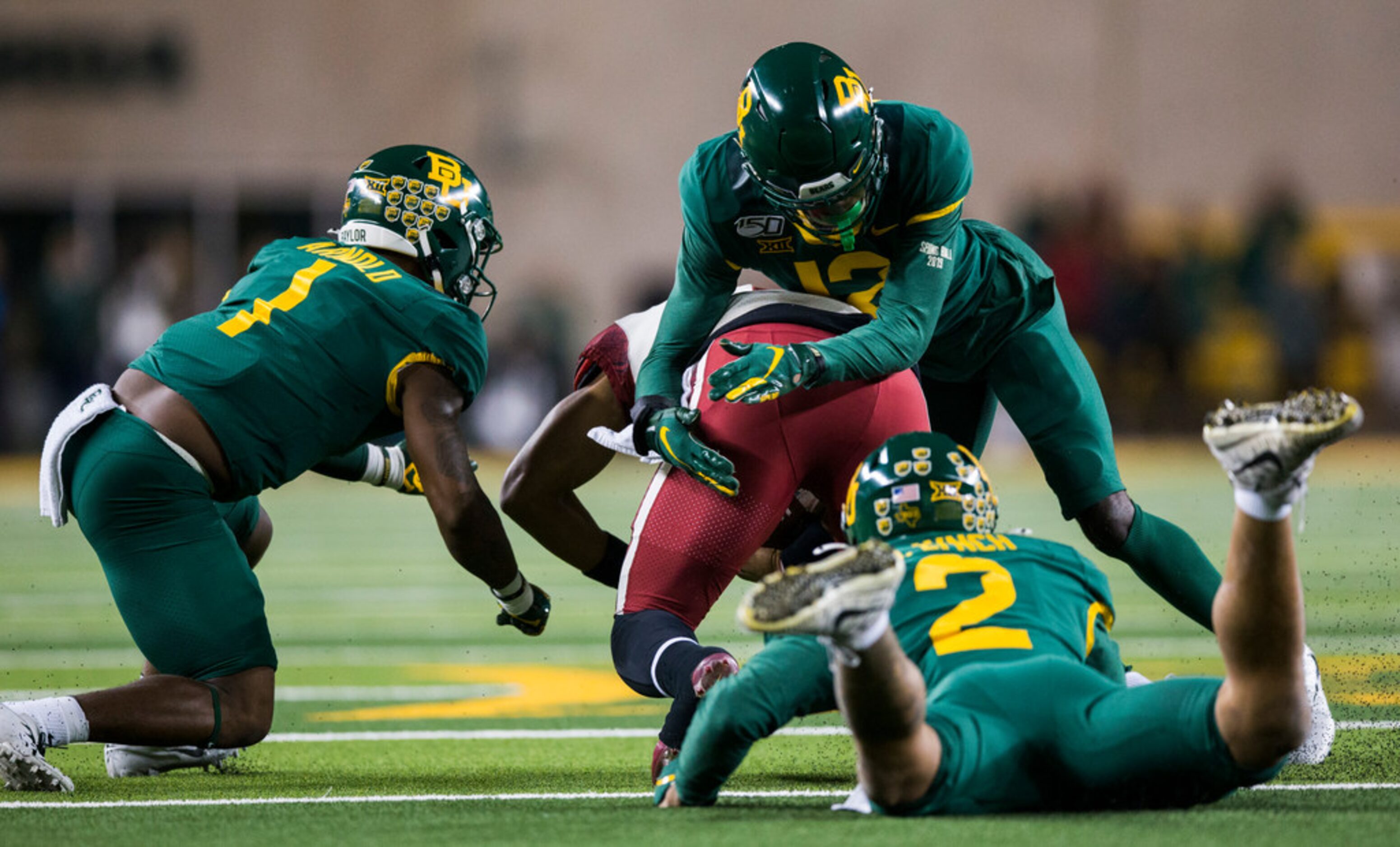 Baylor Bears cornerback Grayland Arnold (1), cornerback Kalon Barnes (12) and linebacker...