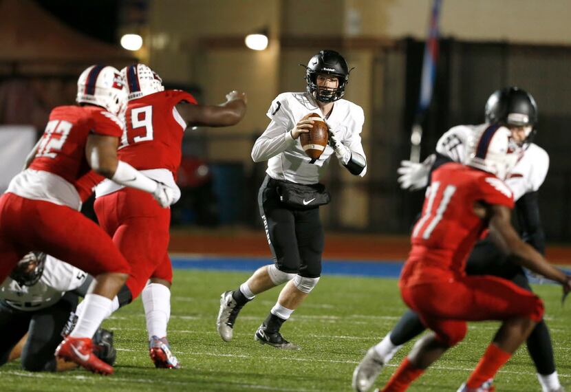 
Bishop Lynch High School Friars Jagger LaRoe looks for receivers during the first half of a...