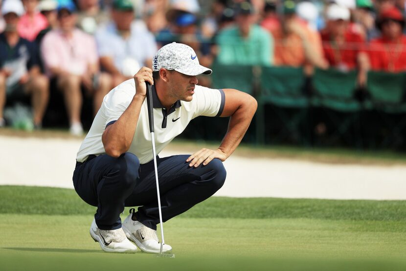 AUGUSTA, GEORGIA - APRIL 12: Brooks Koepka of the United States lines up a putt on the 18th...