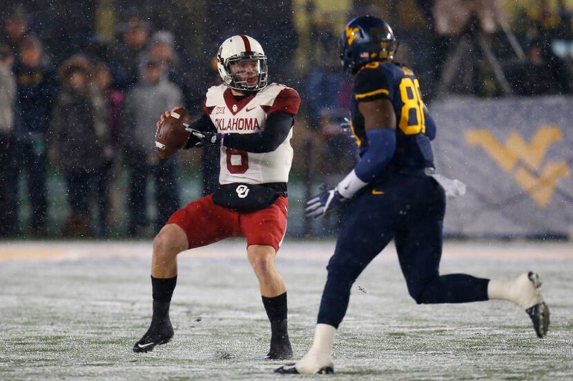 MORGANTOWN, WV - NOVEMBER 19:  Baker Mayfield #6 of the Oklahoma Sooners looks to pass under...