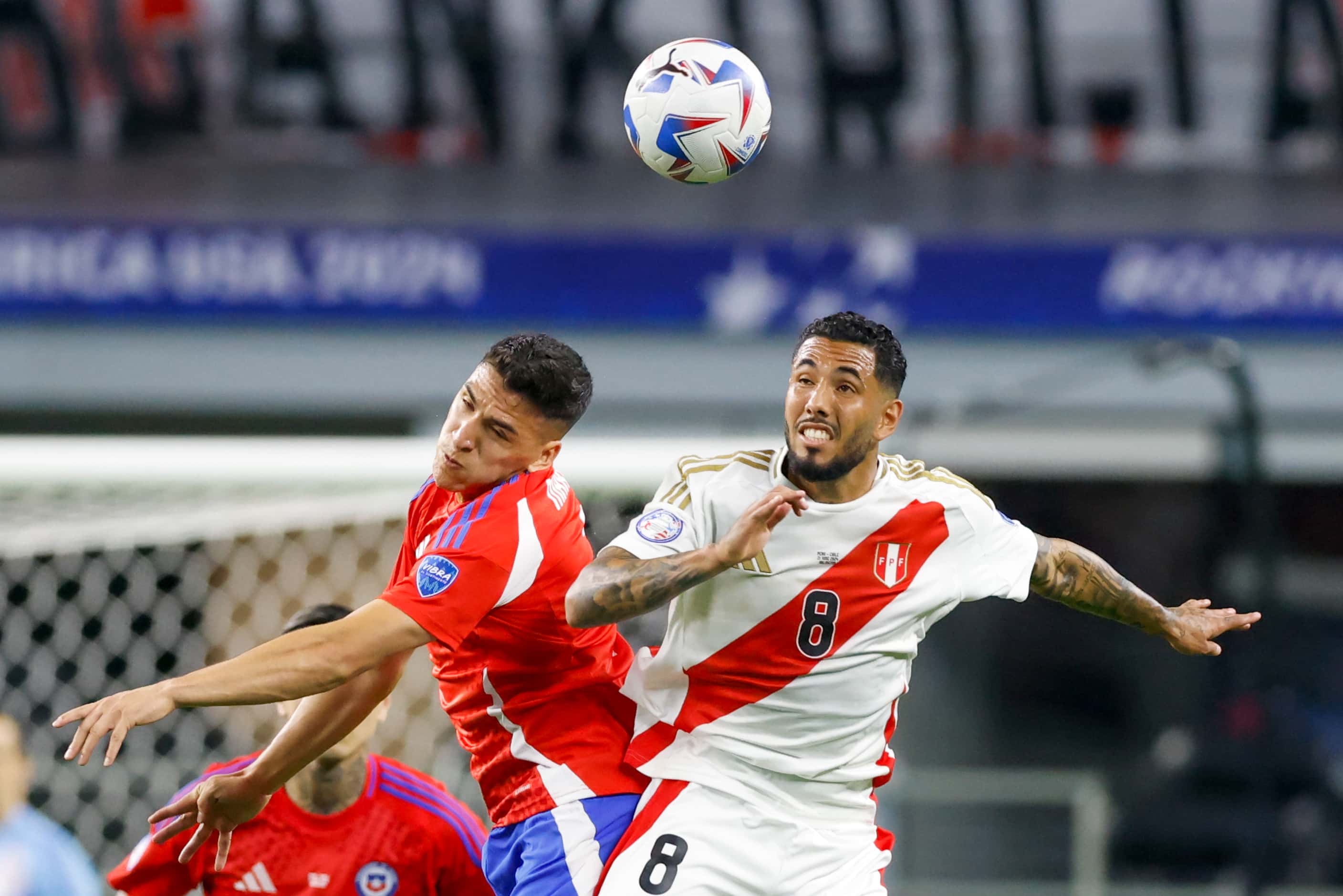 Chile midfielder Marcelino Núñez (7) and Peru midfielder Sergio Peña (8) jump for the ball...