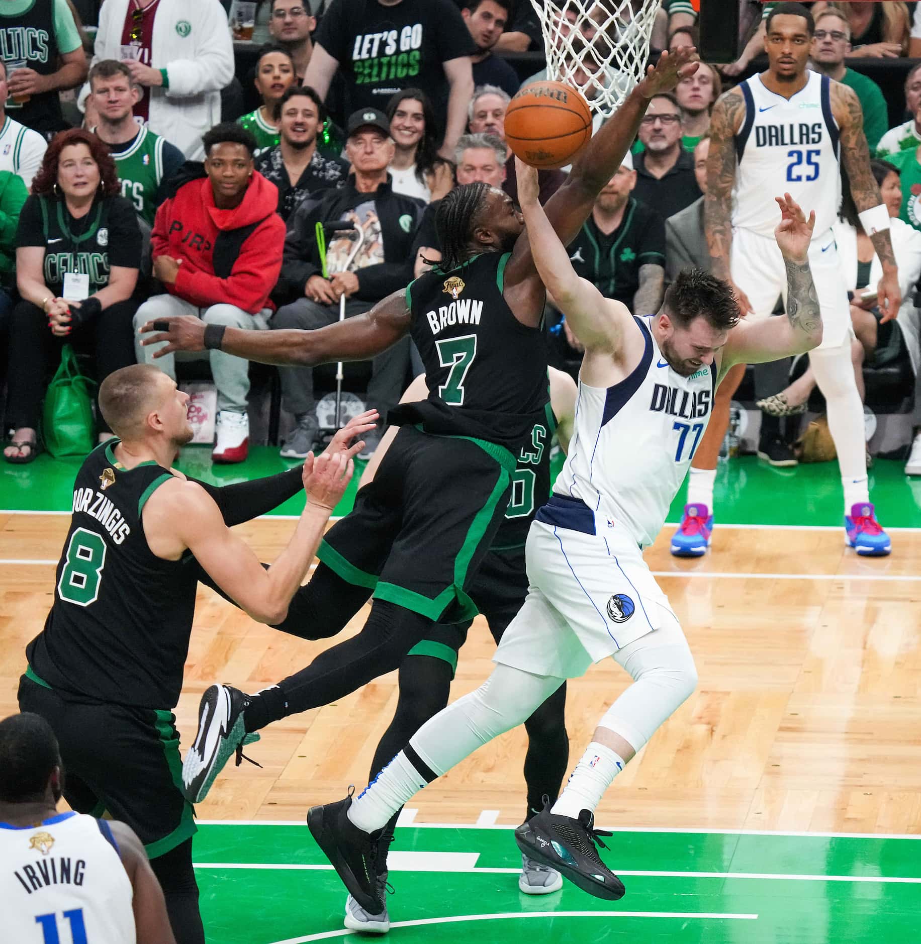 Dallas Mavericks guard Luka Doncic (77) is fouled by Boston Celtics guard Jaylen Brown (7)...