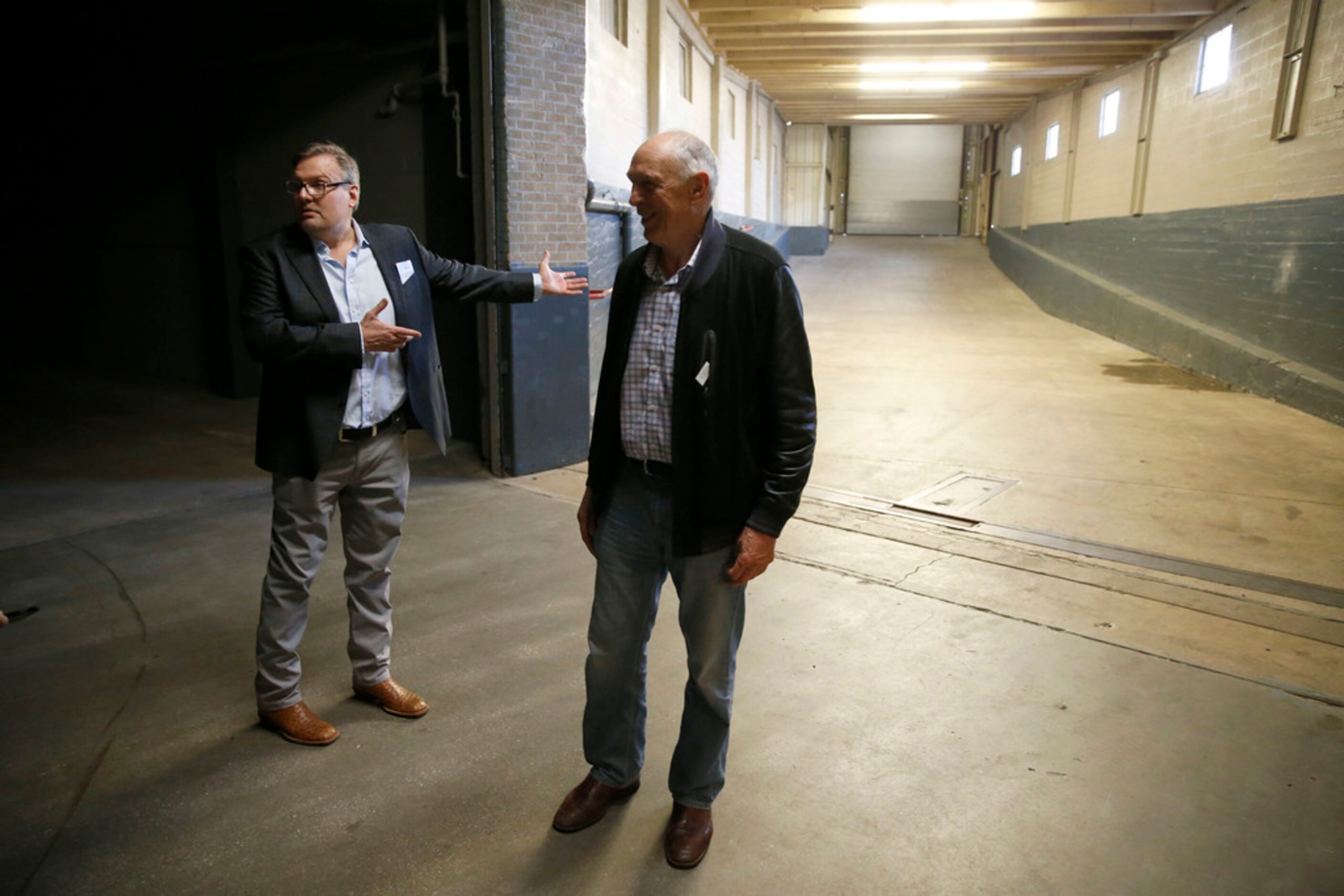 Donnie Nelson, Dallas Mavericks general manager (left) and Holger Geschwindner tour the...