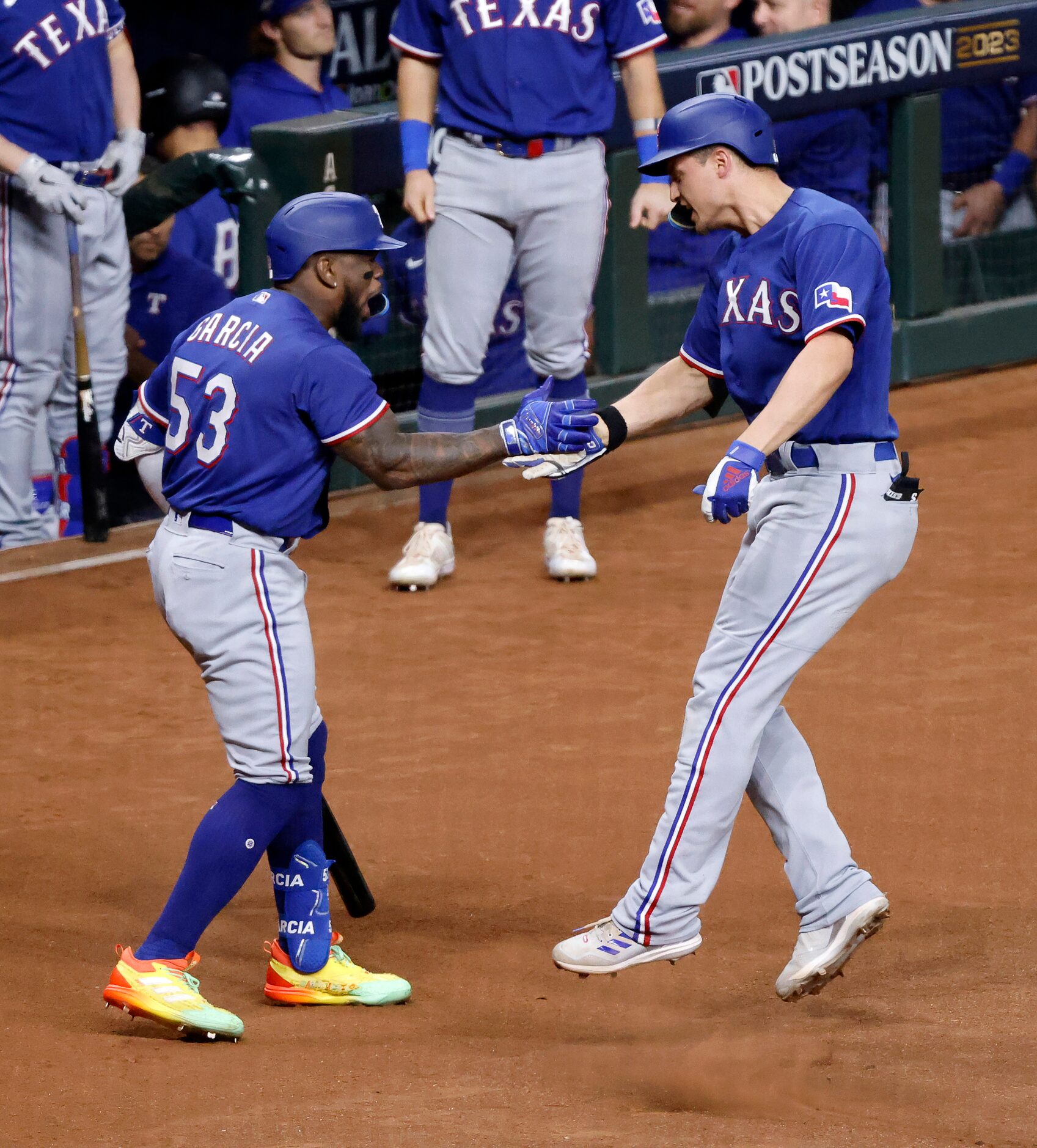 Texas Rangers Corey Seager (right) is congratulated on his solo home run by teammate Adolis...