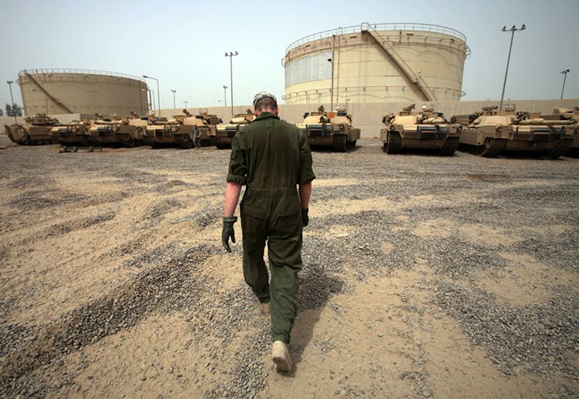  Army Specialist Jacob Woo, 23, walks toward his units tanks to help his fellow soldiers...