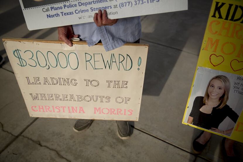 Signs during a protest at the Collin County Jail advertise the reward for information on the...