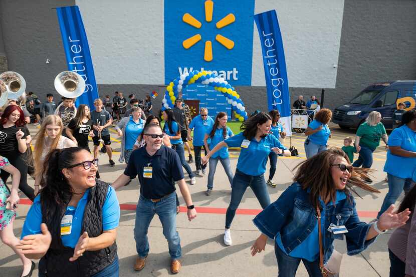 Walmart store managers Marilu Diaz, bottom left, Paul Strunc, center, and human resource...