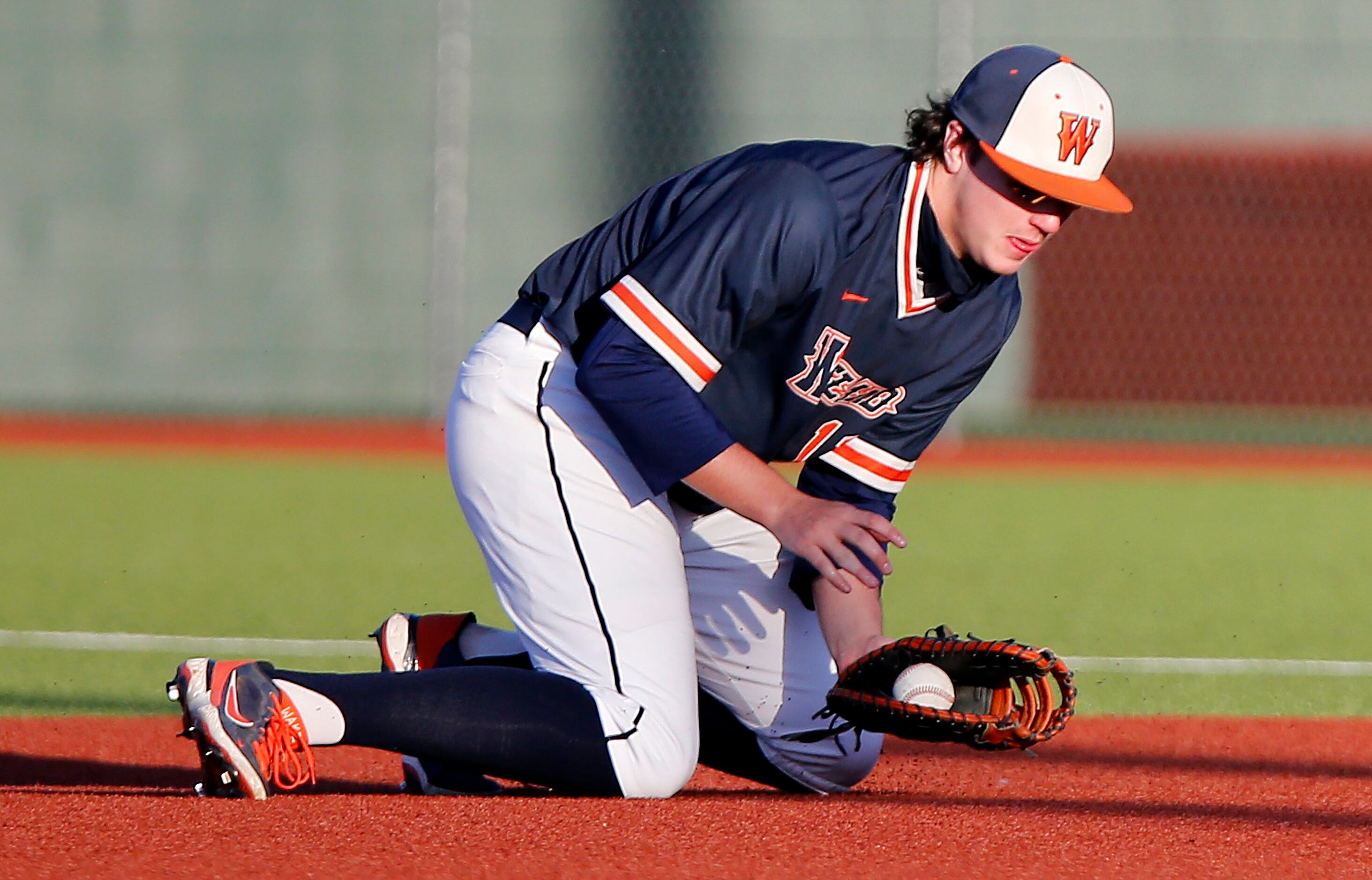 Wakeland High School first baseman Preston Snead (11) stops the ball in the infield and...