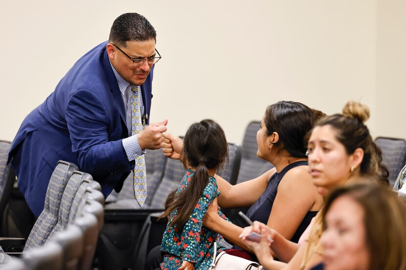 District 5 council member Jaime Resendez fist bumps Fatima Ramirez of Dallas following her...