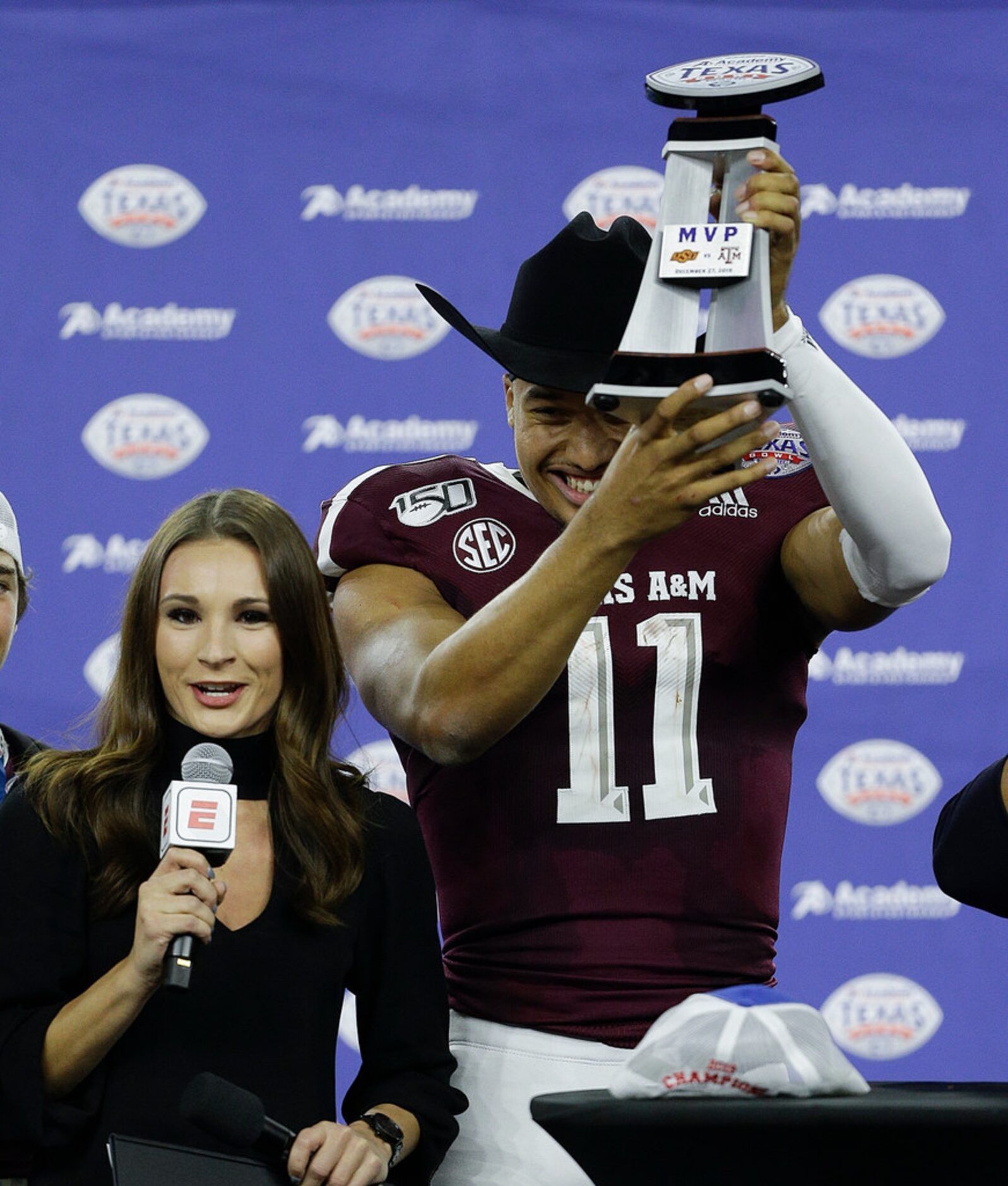 HOUSTON, TEXAS - DECEMBER 27: Kellen Mond #11 of the Texas A&M Aggies receives the MVP...