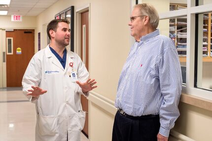 Norbert Schulz stands at the spot in the cardiac catheterization lab where he collapsed from...