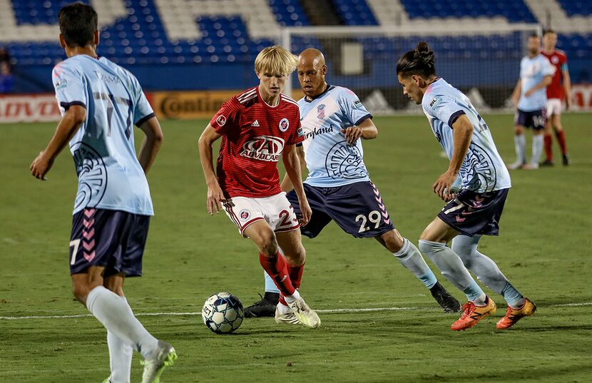 Thomas Roberts keeps his cool while surrounded by three defenders against  Forward Madison...