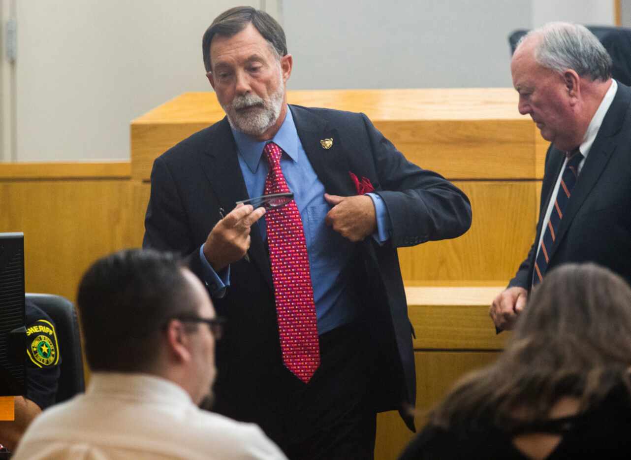 Defense attorneys Stephen Miller, center, and John Tatum, right, take their seats during a...
