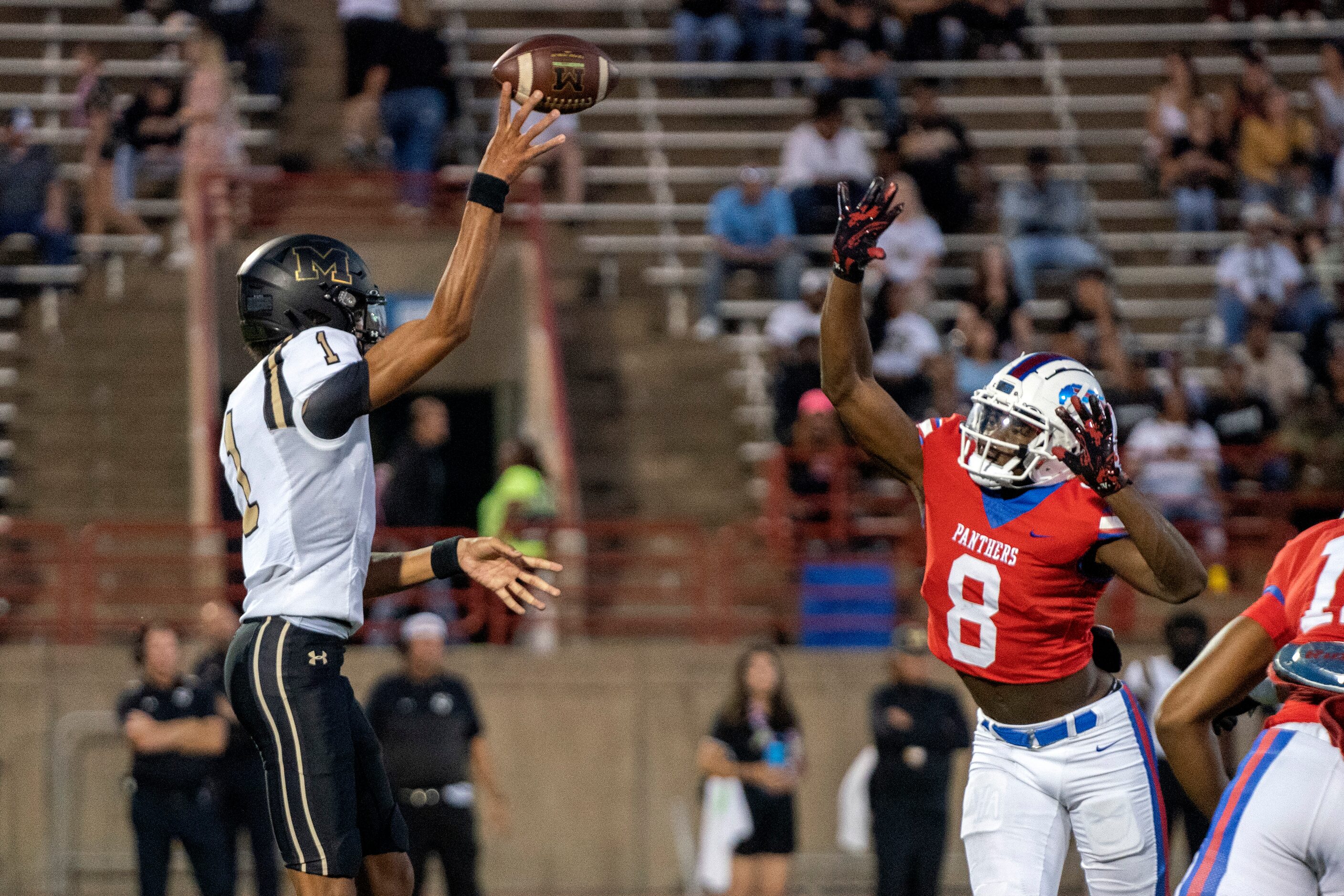 Mansfield senior quarterback Sergio Kennedy (1) lofts a screen pass over Duncanville junior...