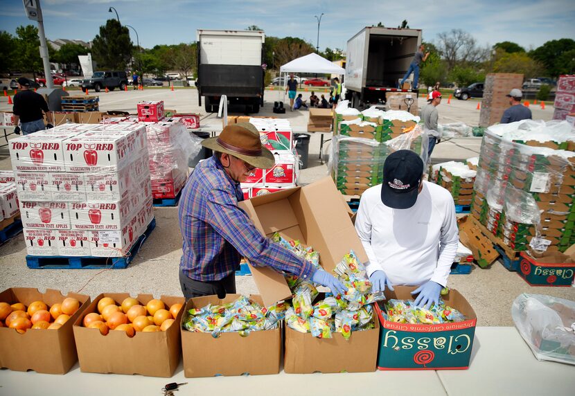 Volunteers Boone Eck (left) and Kyle Oliver of Fielder Road Baptist Church helped with a...