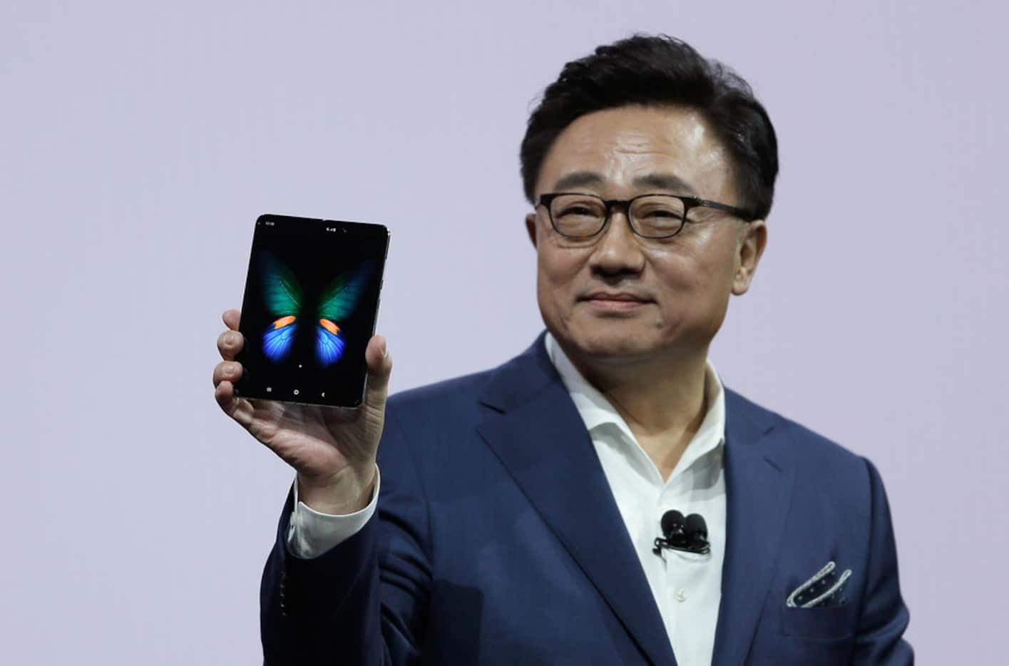 DJ Koh, Samsung President and CEO of IT and Mobile Communications, holds up the new Galaxy...