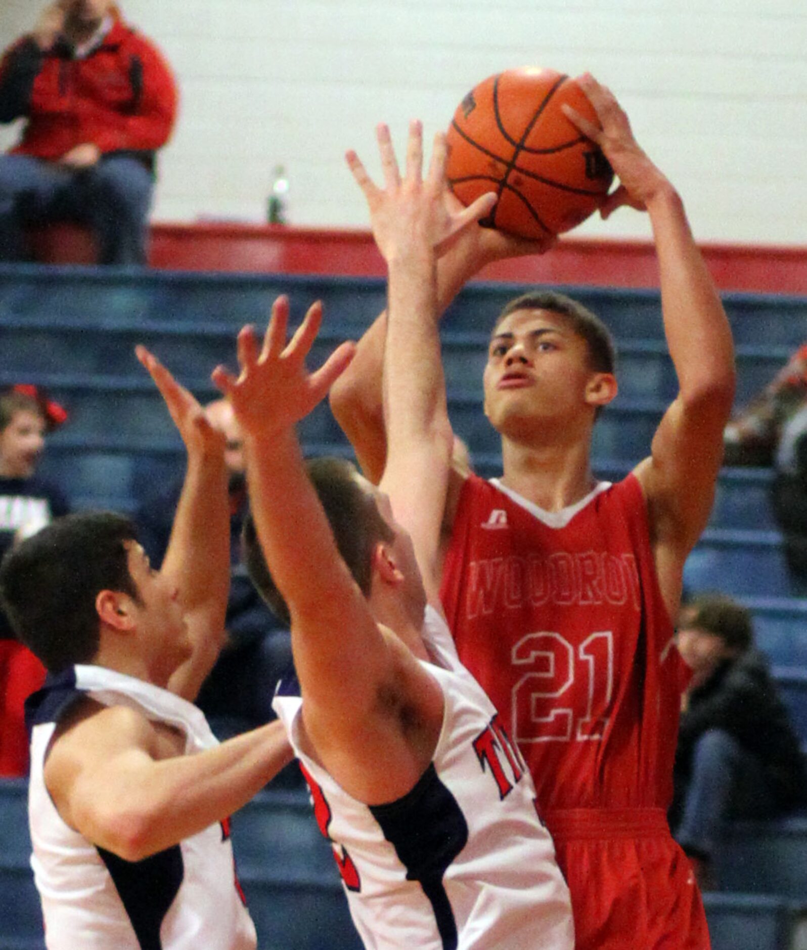 Woodrow Wilson's Mark Crowe (21) shoots over a couple of Frisco Centennial defenders during...