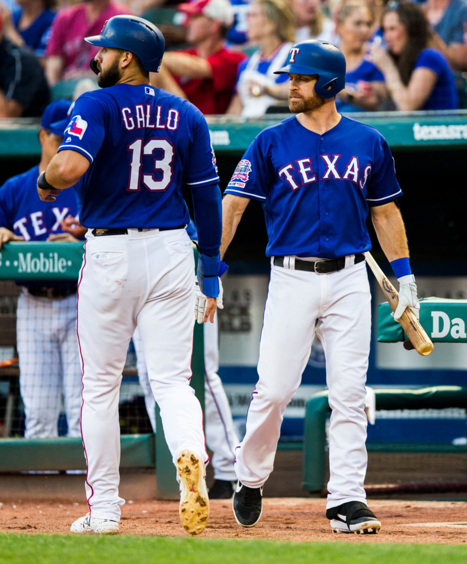 Texas Rangers center fielder Joey Gallo (13) high-fives short stop Logan Forsythe (41) after...